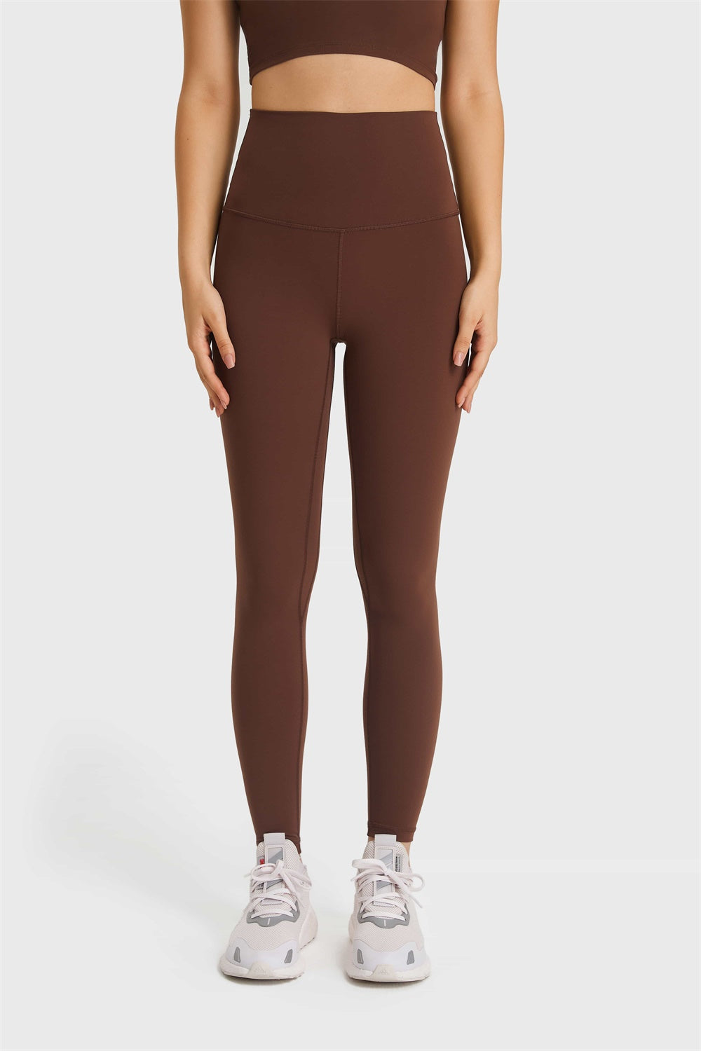 Brown high rise leggings with a seamless waistband and full length legs.