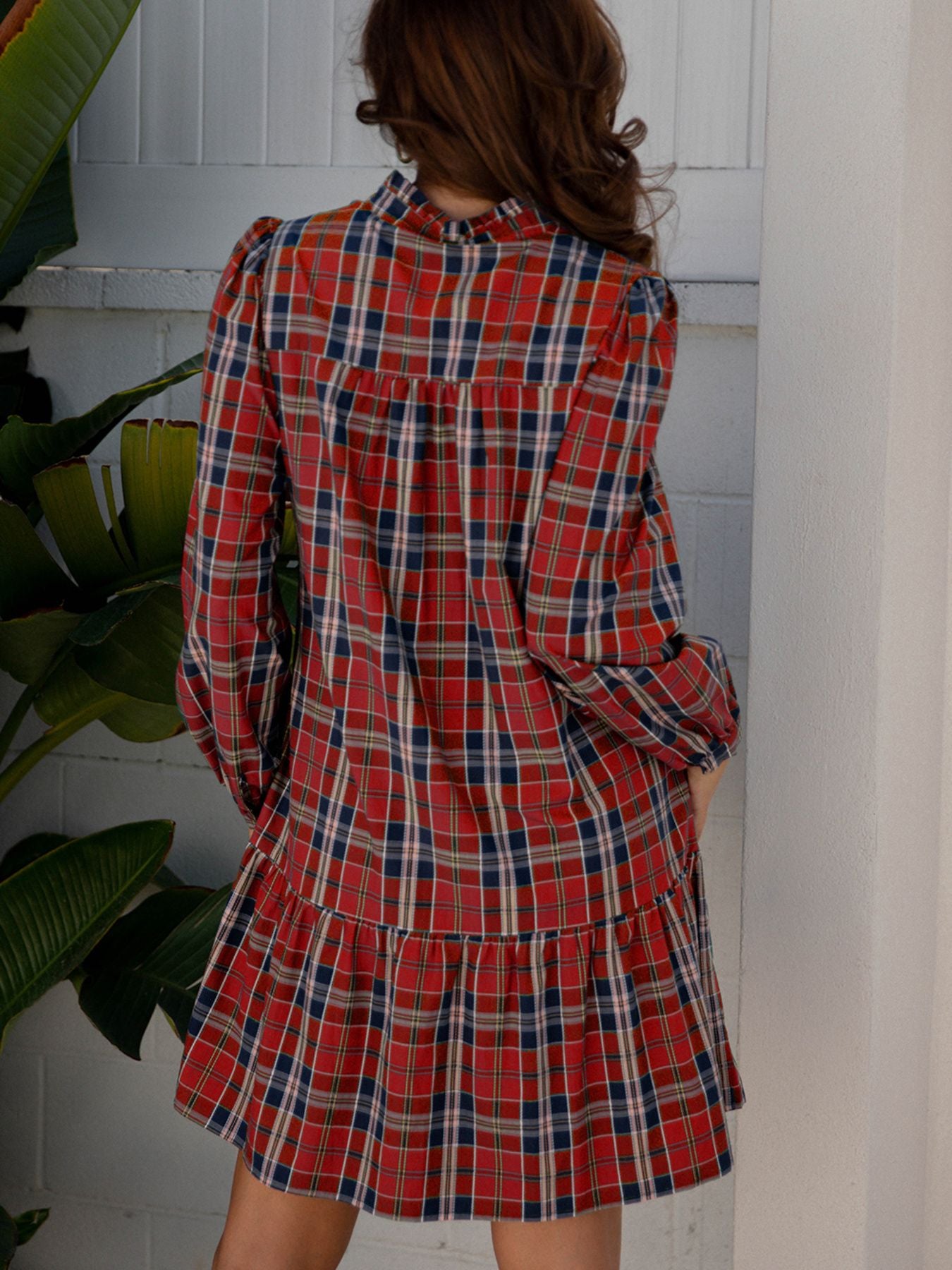 Tartan mini dress with frilly collar and tiered skirt in red, navy, and white plaid cotton blend.