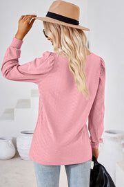 Blush pink diamond-textured puff sleeve top with a round neckline.
