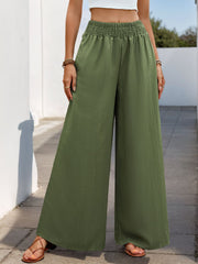 Moss green textured palazzo trousers with elastic waist and wide legs.
