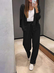 Black button-front lounge set with drawstring pants and white tank top.