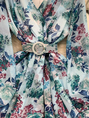 Light blue floral ruffle hem wrap mini dress with cinched waist and belt.