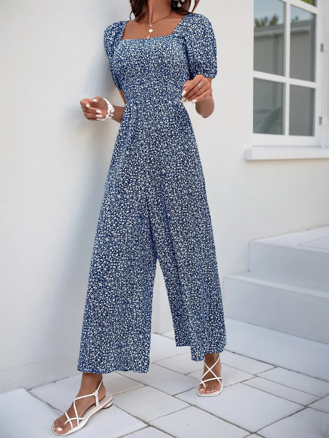 Smocked bodice floral jumpsuit with puff sleeves and wide legs in Royal Blue.
