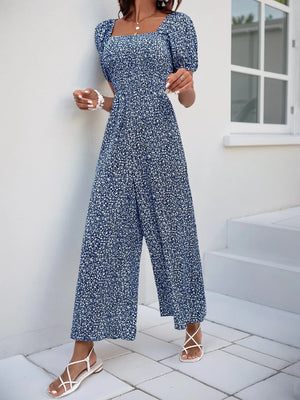 Smocked bodice floral jumpsuit with puff sleeves and wide legs in Royal Blue.