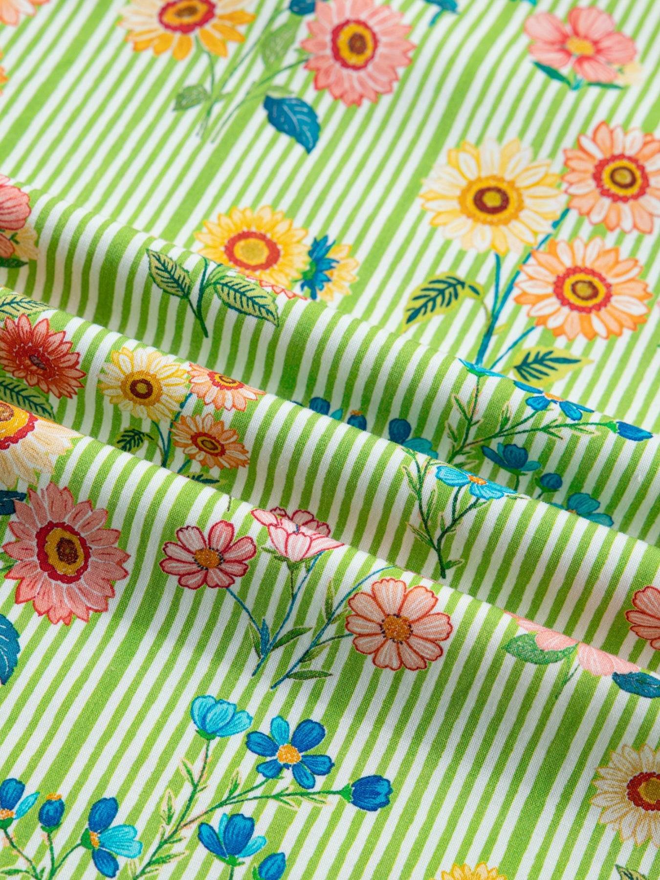 Floral printed cotton blouse with green and white stripes, featuring ruffled short sleeves.