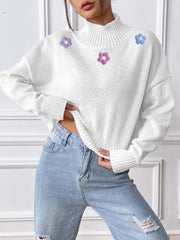 White cropped turtleneck sweater with embroidered purple and blue flowers
