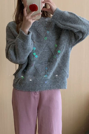 Gray diamond knit sweater with colorful sequin embellishments and crew neck.