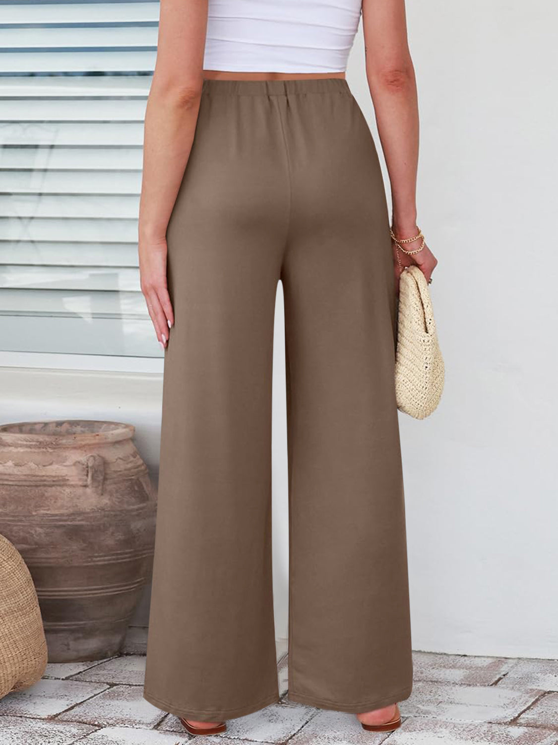Pleated palazzo trousers in taupe with pockets and a wide leg.