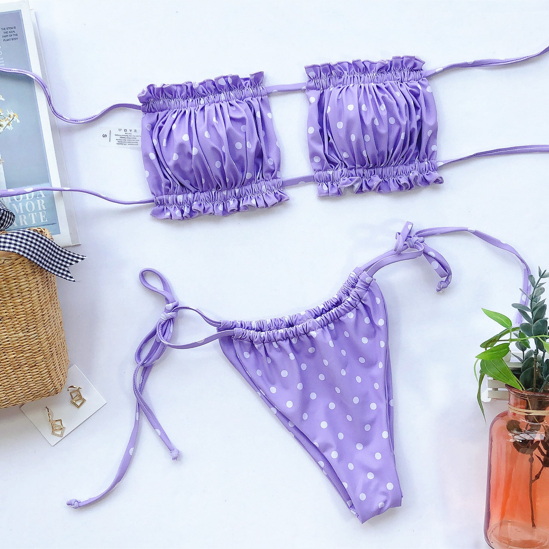 Lavender polka dot bandeau bikini set with ruffled trim and tie sides.