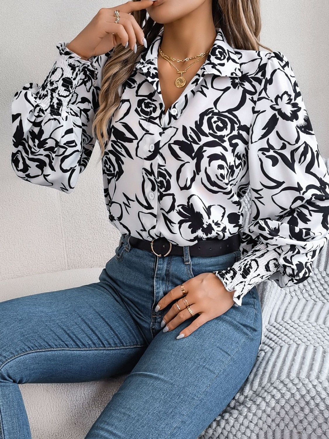 White floral print blouse with button front and shirred cuffs