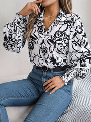 White floral print blouse with button front and shirred cuffs