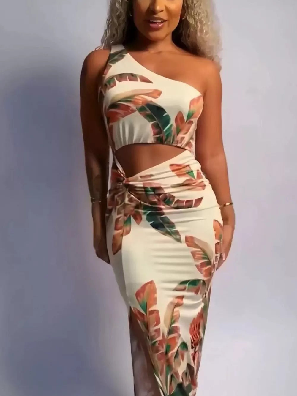 Tropical cutout maxi dress with one shoulder, side slit, and leaf print.