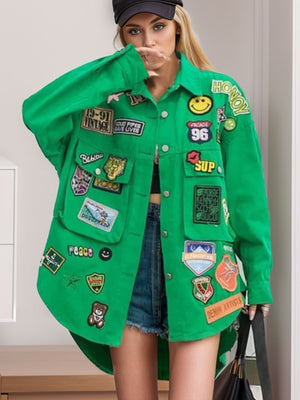 Green denim trucker jacket with embroidered patches, oversized fit, buttoned front, and chest pockets.