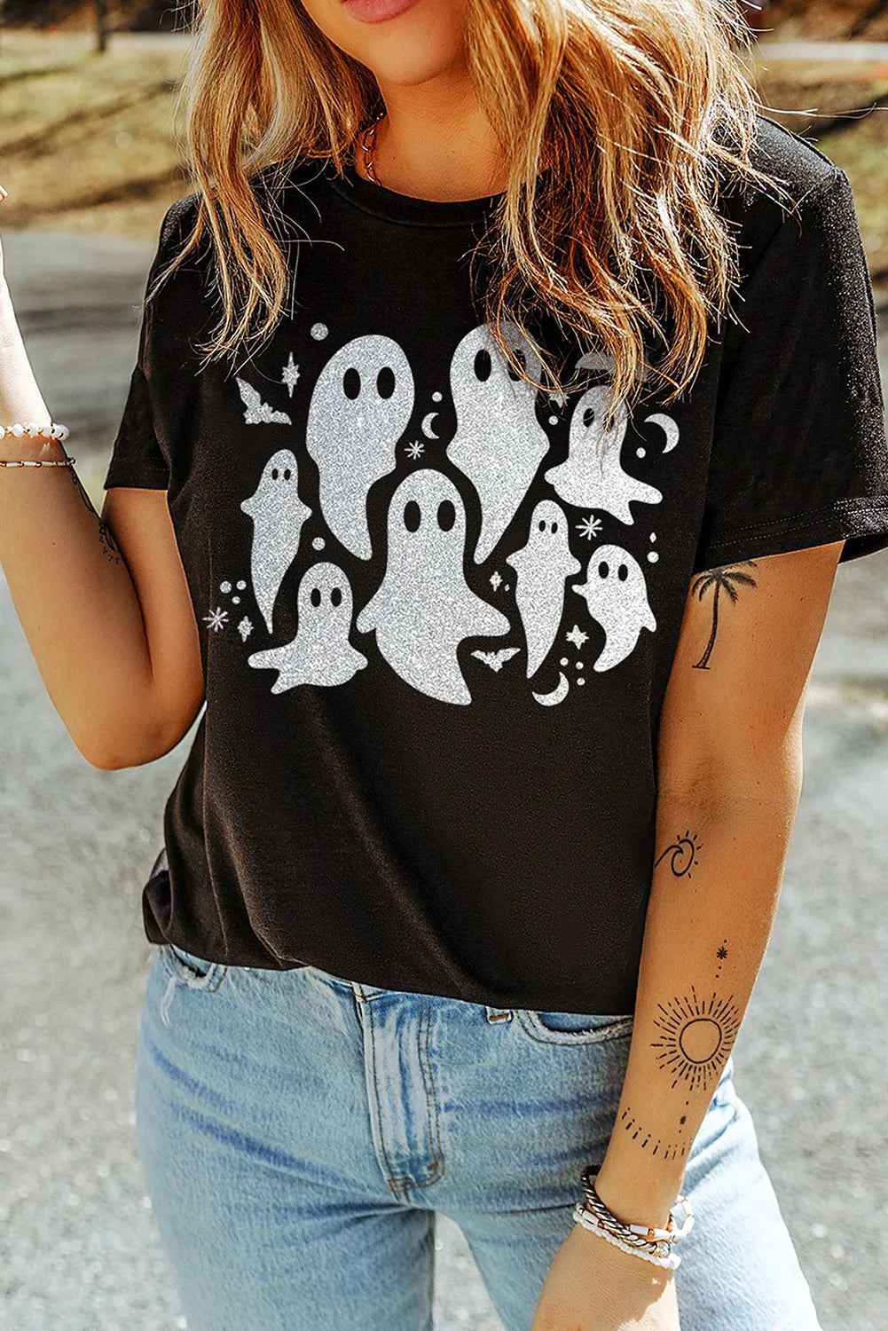 Black t-shirt with a glittery ghost graphic and bats, moons, and stars.