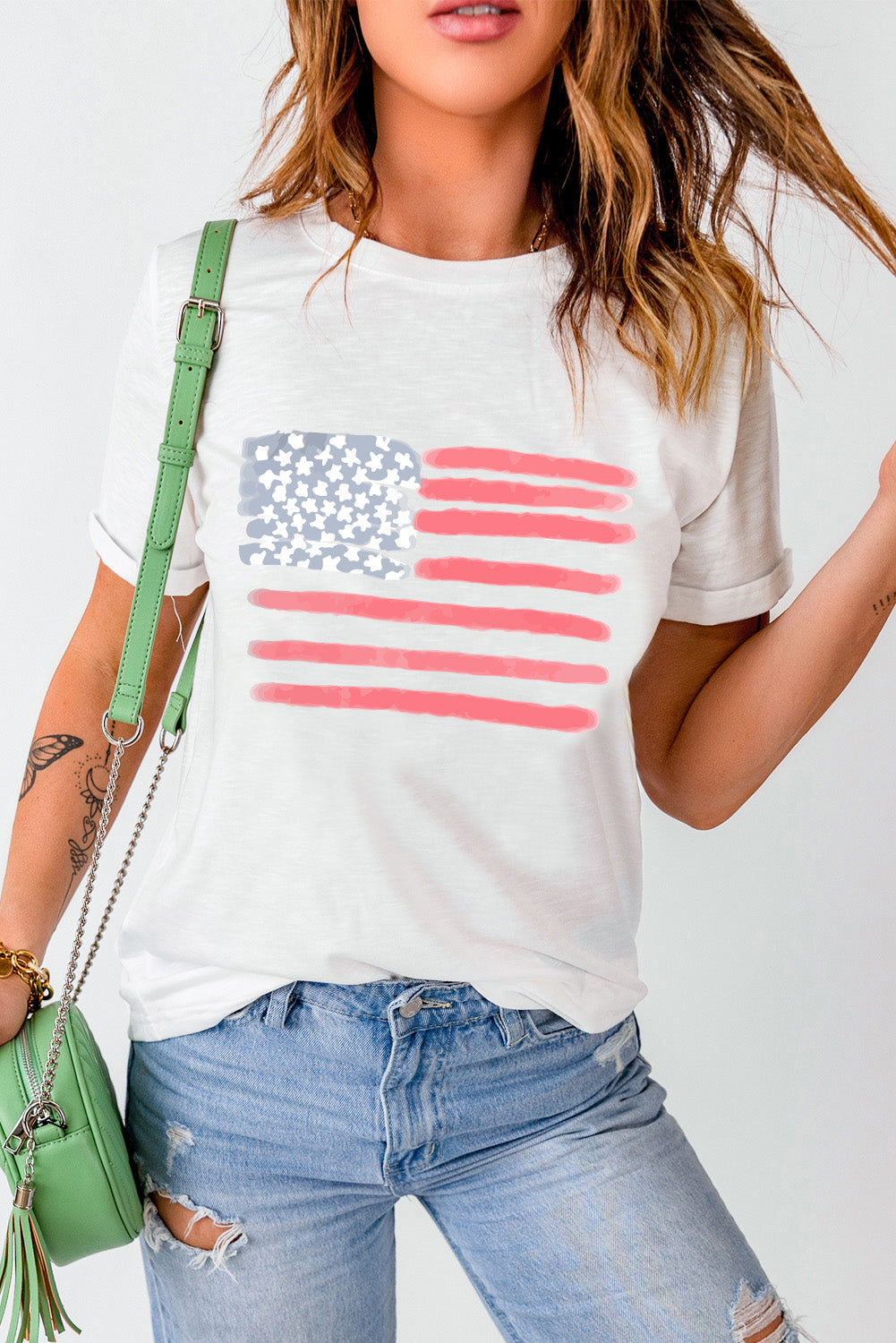 White crewneck tee with a painted American flag graphic, casual artsy style.