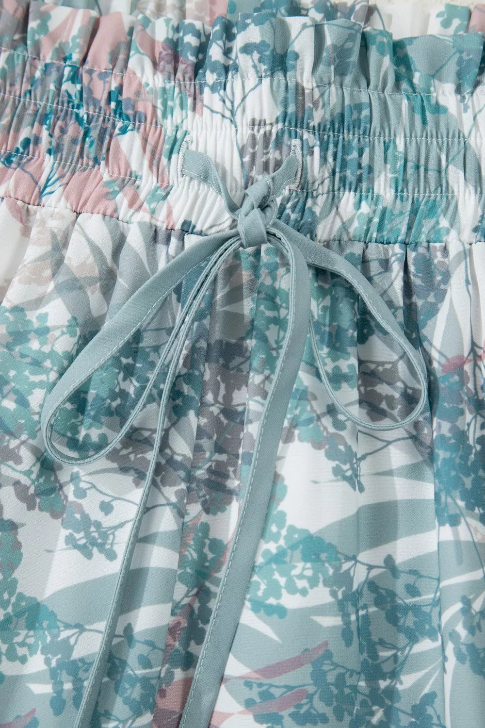 Botanical print maternity swimwear with drawstring waist and pockets.
