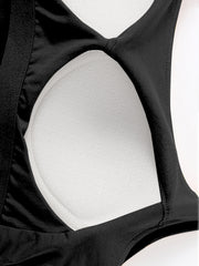 Black built-in bustier crop camisole with white textured lining and elastic trim.
