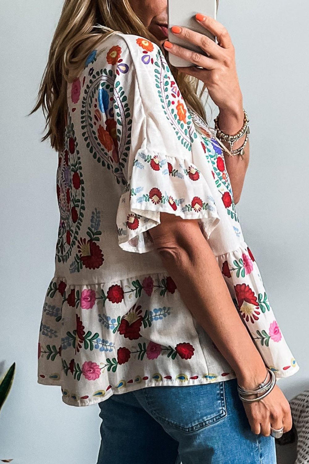 Embroidered medallion peplum blouse with ruffles in floral.