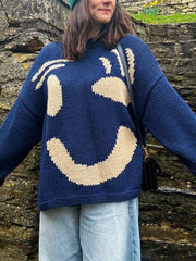 Blue knit sweater with abstract cream graphic pattern, crewneck, long sleeves.