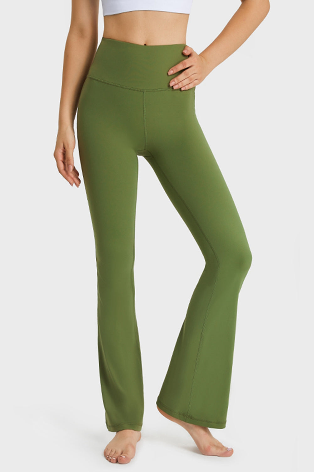 Green flare yoga pants with high waist and breathable fabric.