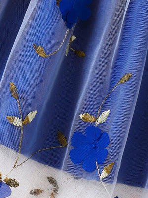 Toddler dress with blue floral embroidery and gold leaf accents on white tulle overlay.