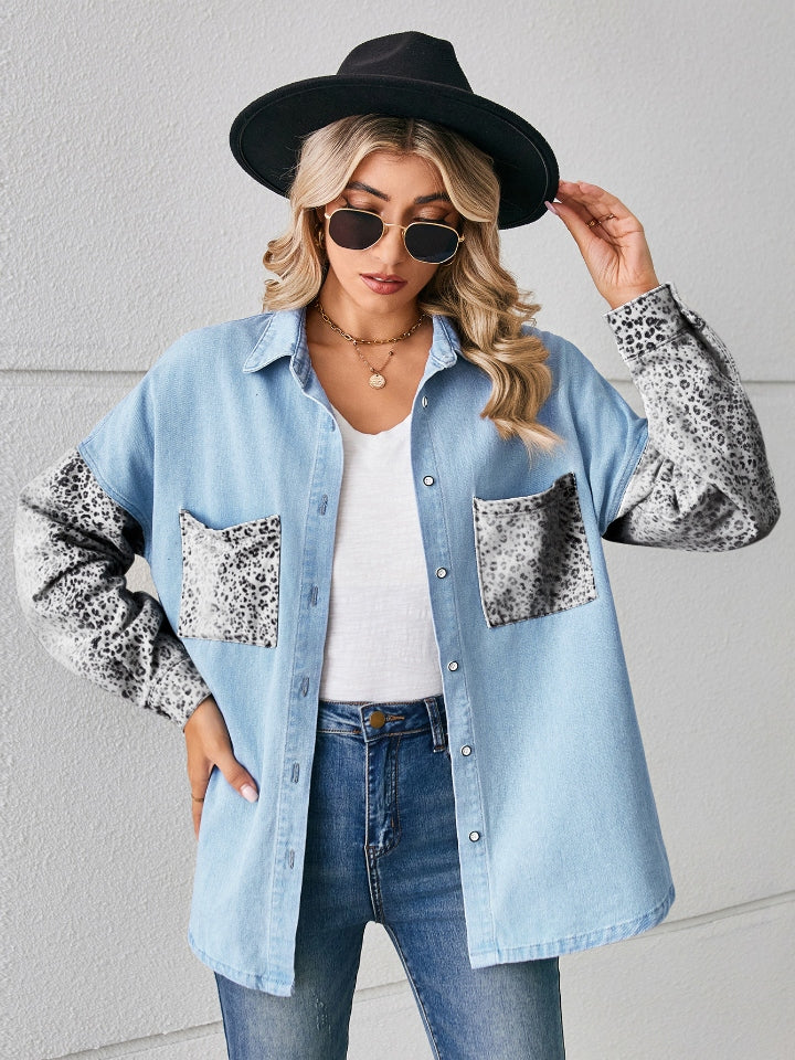 Light blue denim overshirt with leopard print sleeves and pockets.