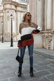 Crewneck knit sweater with horizontal color blocking in brown, white, dark gray, and rust.