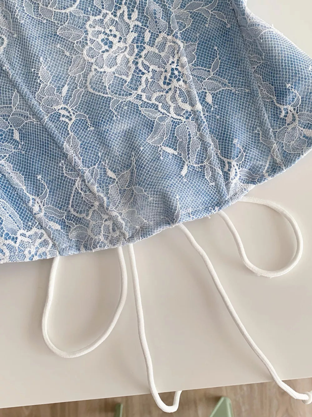 Blue lace tube top with white floral overlay and adjustable drawstring detail