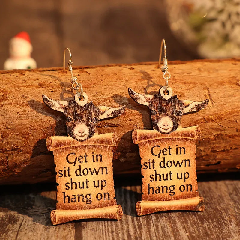 Goat head scroll drop earrings in camel with text saying Get in sit down shut up hang on.