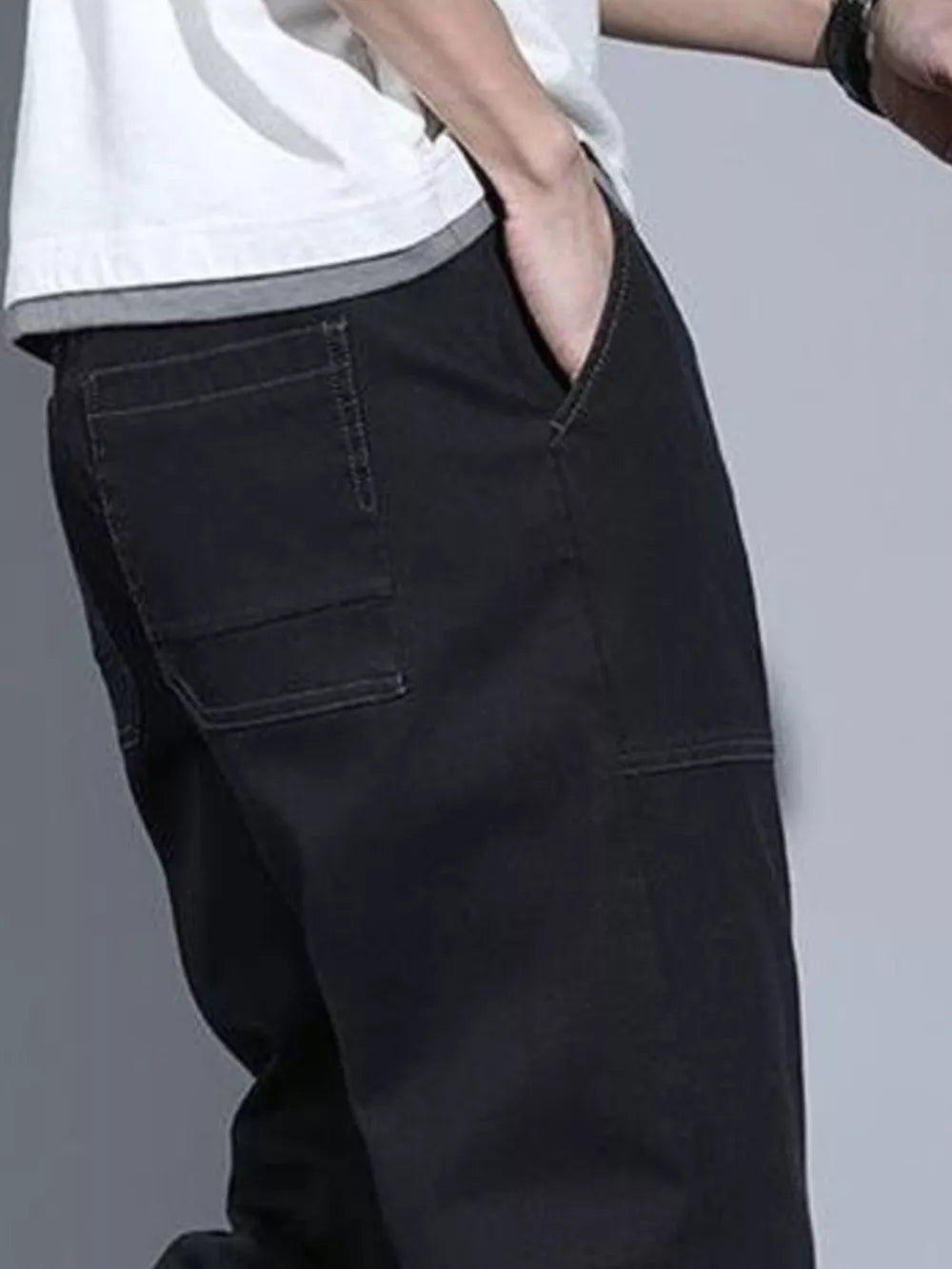 Black drawstring jogger jeans for men with contrast stitching and back pockets.