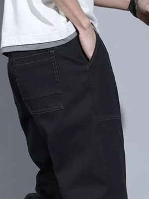 Black drawstring jogger jeans for men with contrast stitching and back pockets.