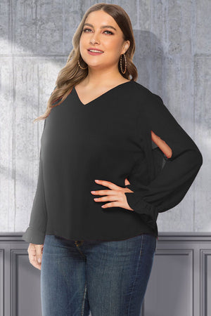 Black V-neck blouse with sleeve cutouts and ruffled cuffs