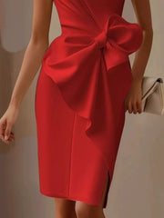 Red sleeveless dress with a large bow detail and a side slit.