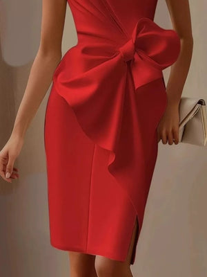 Red sleeveless dress with a large bow detail and a side slit.