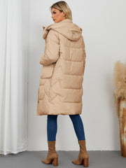 Camel quilted puffer parka with hood and buckle detail, long length.