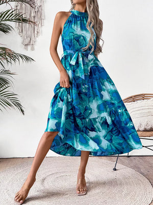 Blue floral halter neck midi dress with tiered skirt and self-tie belt.