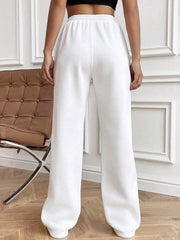 White pleated palazzo drawstring trousers with a wide leg