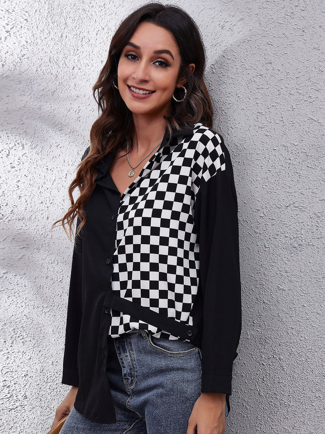 Checkerboard panel button-down blouse in black and white polyester with a collared neckline.