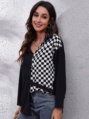 Checkerboard panel button-down blouse in black and white polyester with a collared neckline.