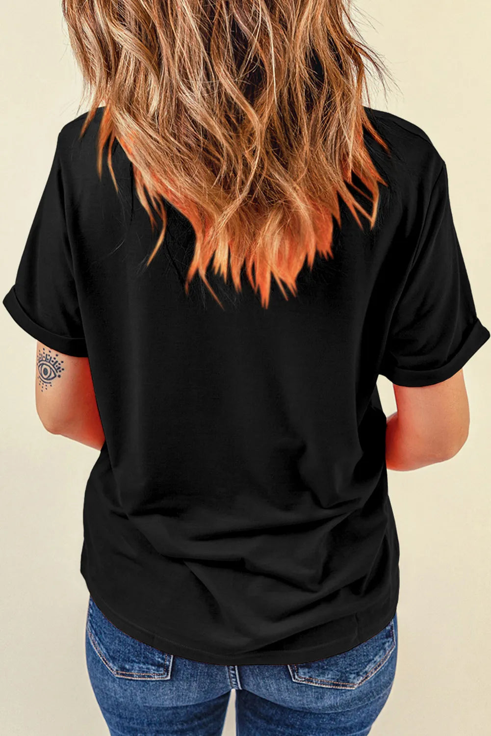 Black graphic t-shirt with rolled sleeves and a relaxed fit.