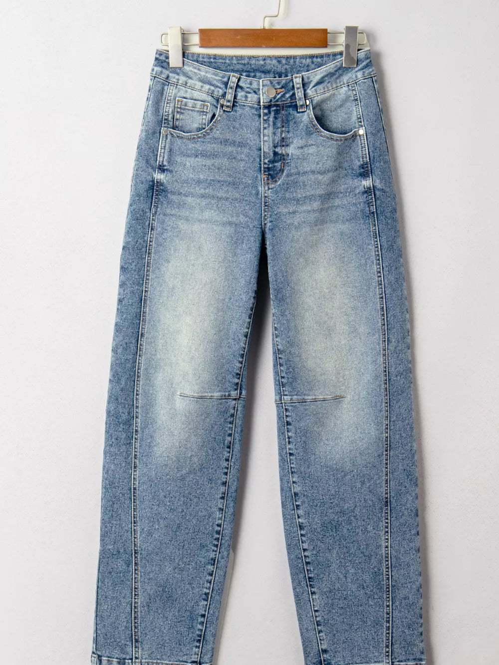 Vintage-inspired high-waisted seam jeans in light wash denim with cuffed hems.