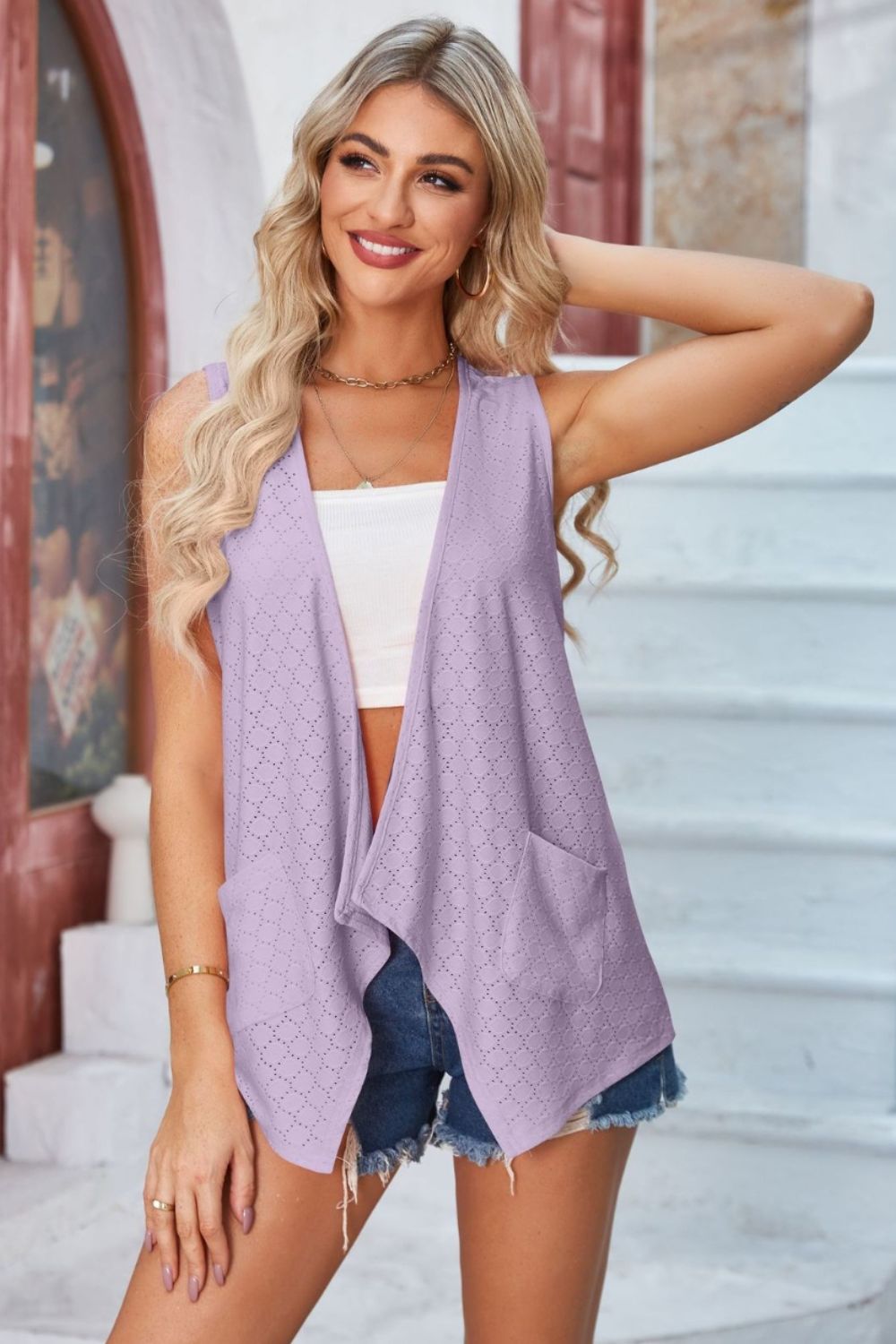 Lilac eyelet drape front vest with pockets and open neckline.