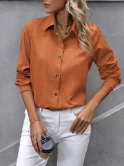 Orange linen-blend button-down shirt with a collared neckline and long sleeves.