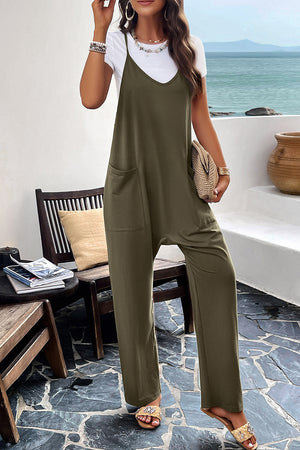 Army green relaxed drape pocket jumpsuit with V-neck and wide legs, layered over a white tee.