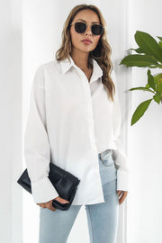 Oversized white cotton poplin button-up shirt with long sleeves and a classic collar.