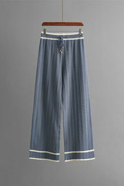 Dusty blue ribbed knit loungewear pants with contrast trim and drawstring waist.