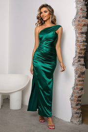 Green satin one-shoulder gown with ruched detailing and a thigh-high slit.