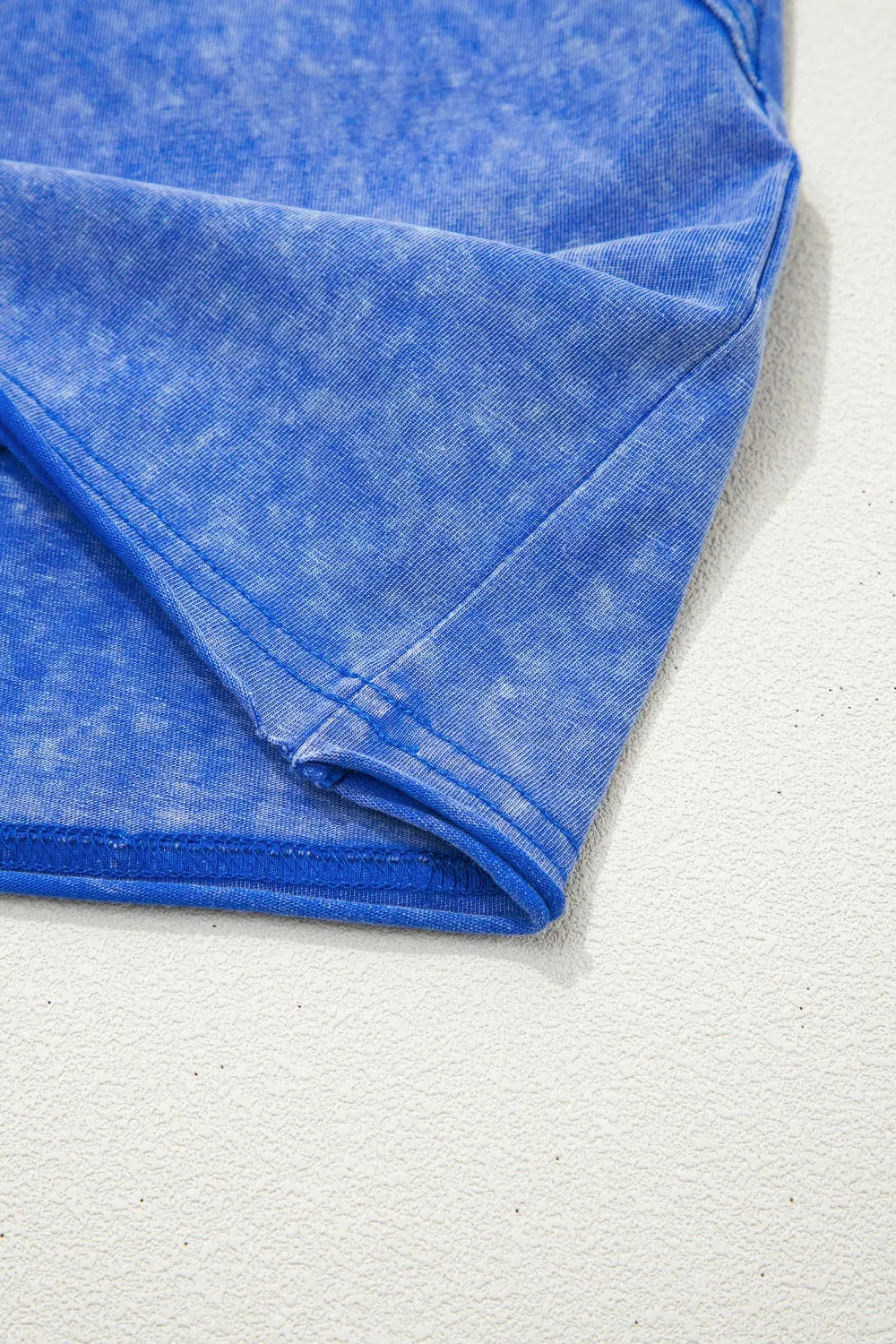 Blue mineral wash cotton t-shirt with distressed texture and subtle lace trim detail
