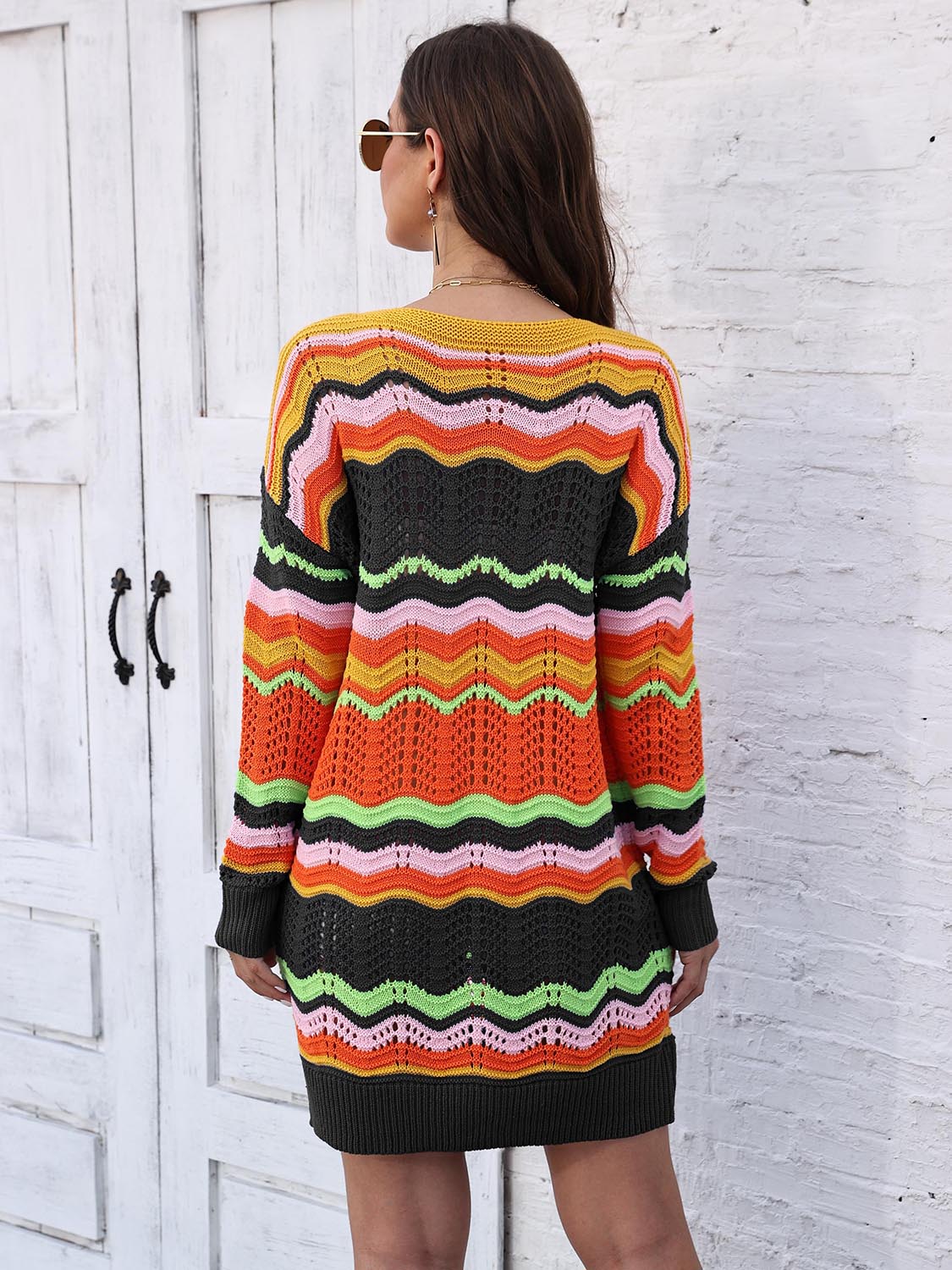 Chevron stripe knit mini dress with crochet details in orange, pink, green, yellow, and black.