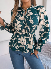 Deep Teal floral peplum blouse with ruffled neck and tie detail, long sleeves.